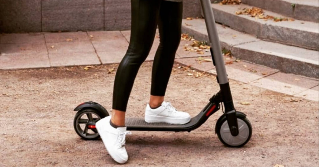 Girl riding with electric scooter