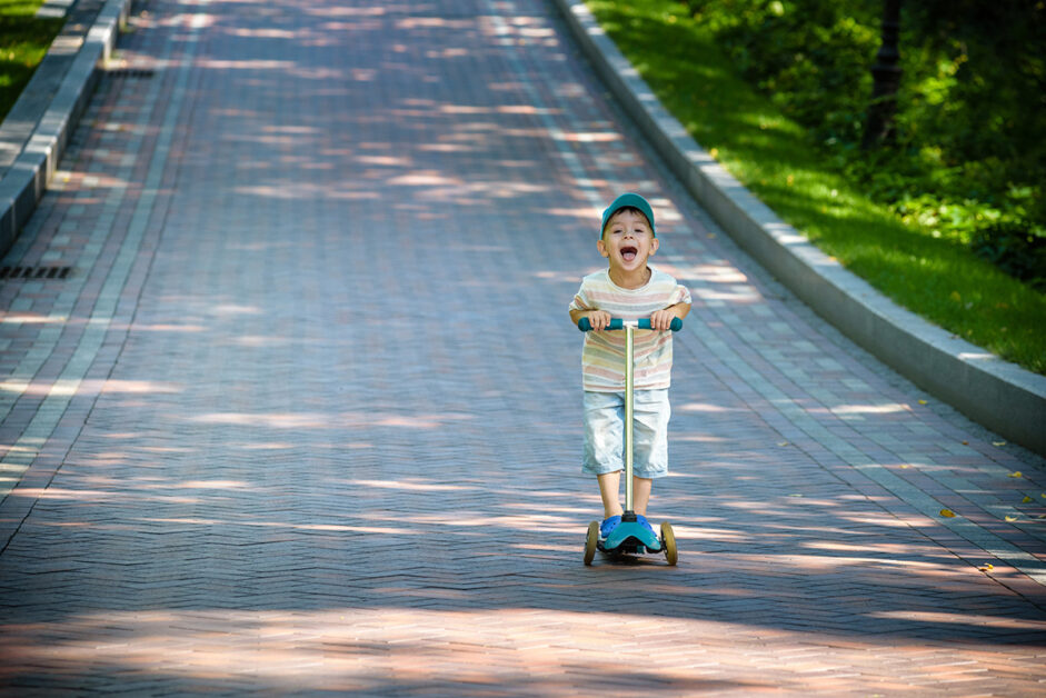 boy rides with a 3-wheel electric scooter
