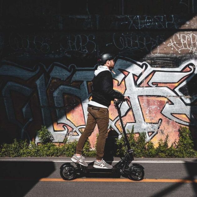 apollo ghost electric scooter riding on a street