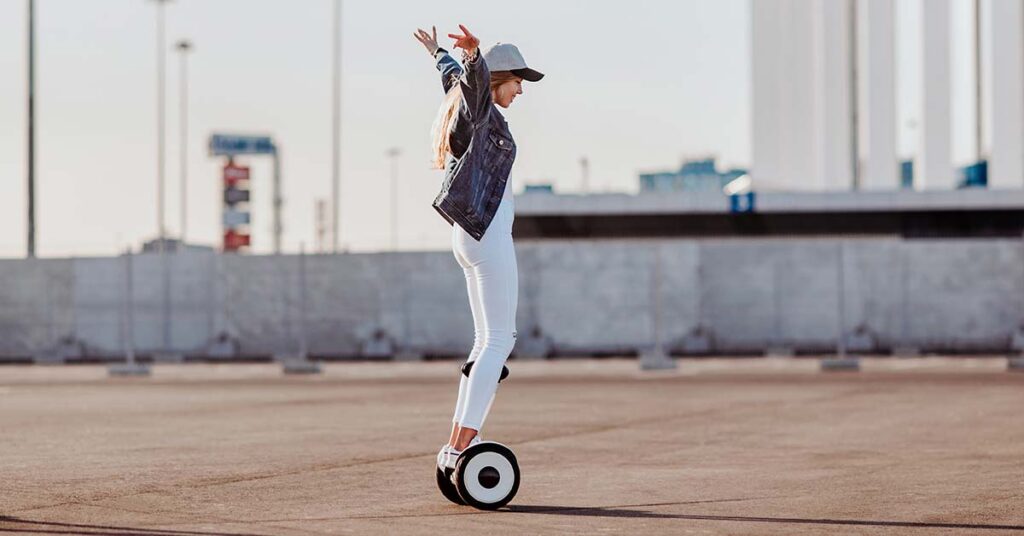 a girl is riding with a white hoverboard