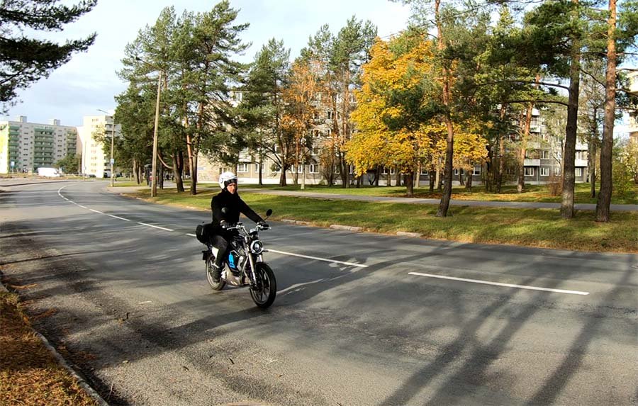 A man riding with an electric moped