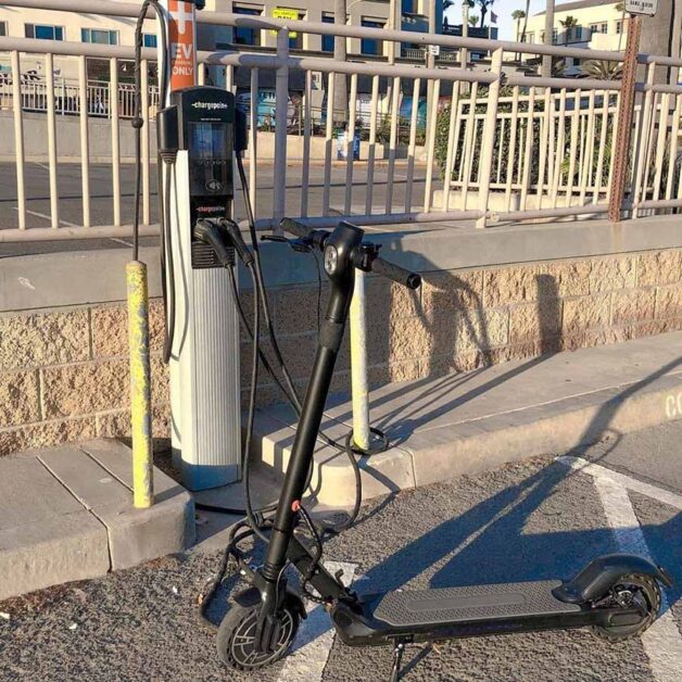 Electric scooter is charging outside