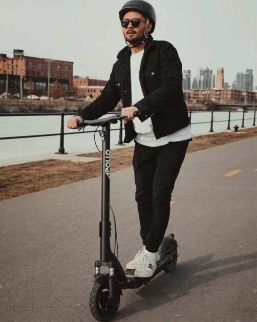 A guy riding with an Apollo Air scooter