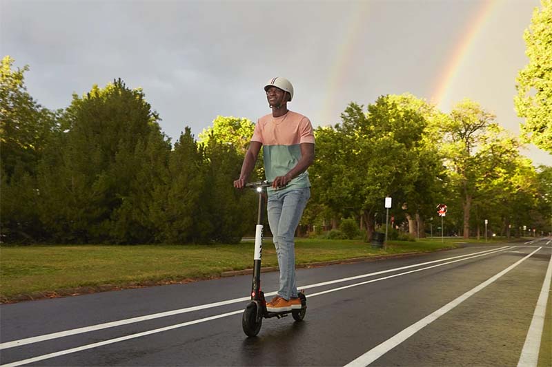 a man is riding with an affordable Gotrax electric scooter