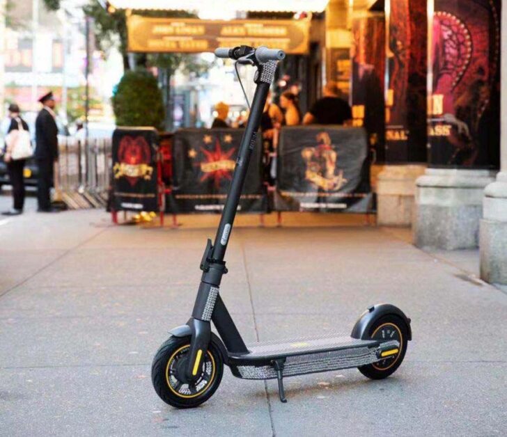 Ninebot Max electric scooter standing on a pavement.