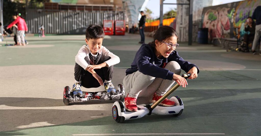 children are having fun while riding with hoverboards