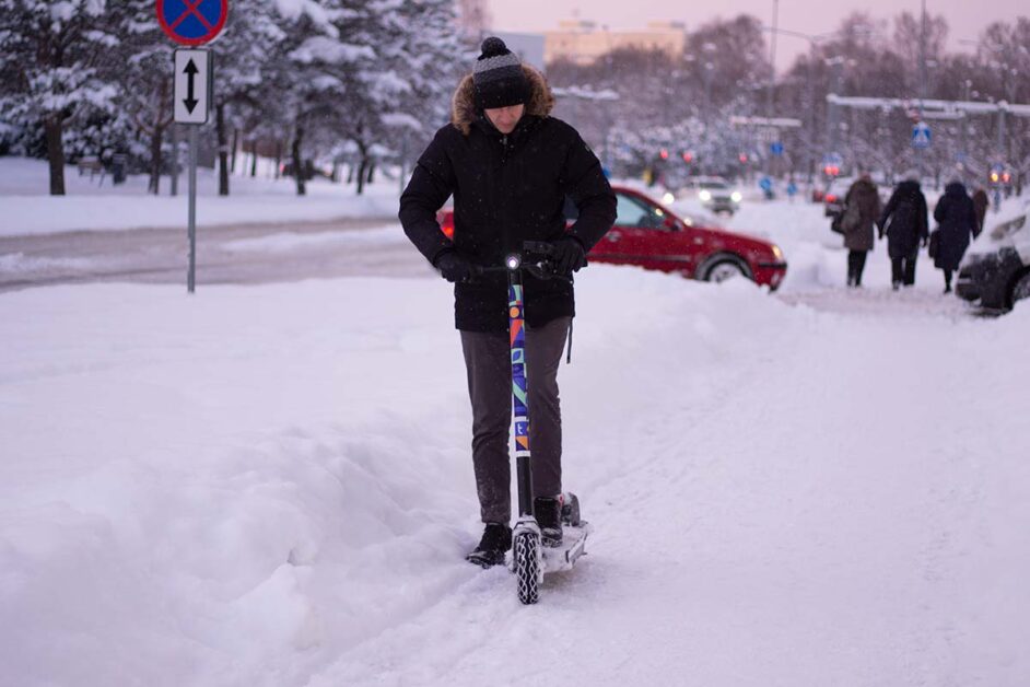 man riding with Tuul electric scooter on the snow