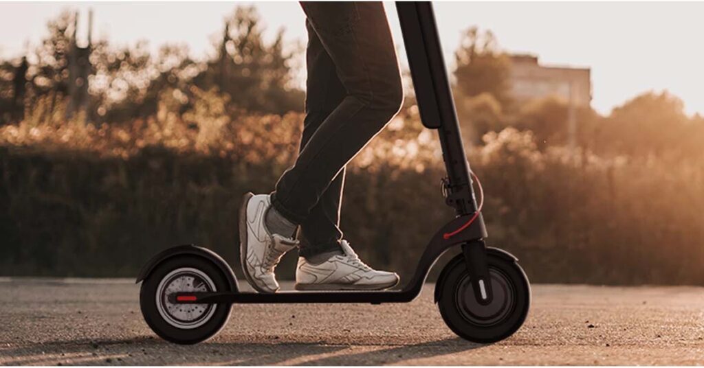 man is standing on Turboant x7 Pro electric scooter