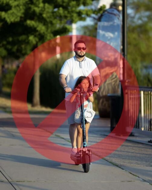 Father and daughter ride with 1 scooter