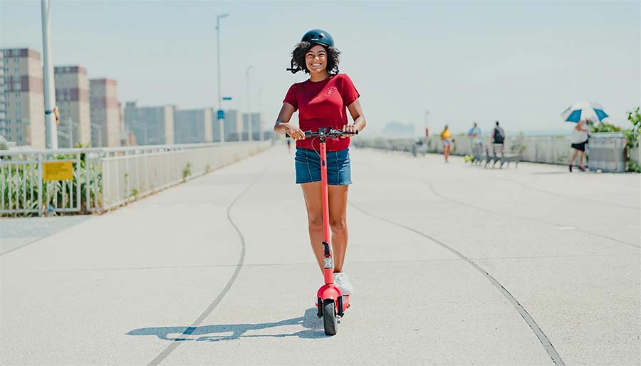 Girl is riding with Hover-1 Alpha electric scooter