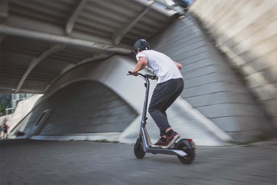 guy riding an electric scooter really fast