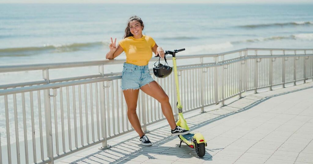 pretty girl poses with Hover-1 electric scooter