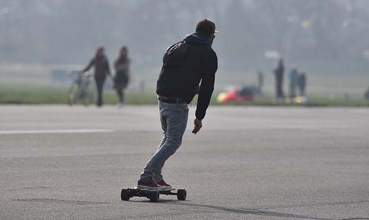 man is riding with an e-board