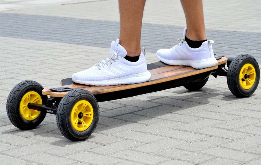 man standing on an Evolve e-board