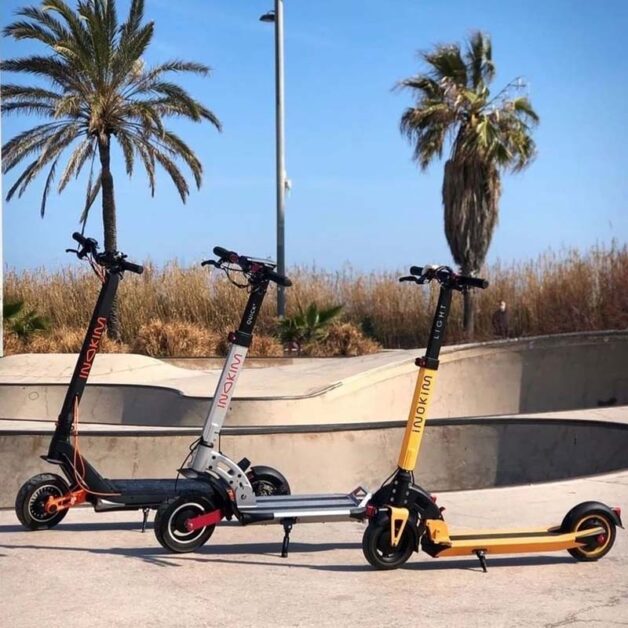 black, gray, and yellow Inokim scooters standing on the street