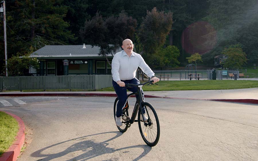 The bald guy with a big smile on his face riding with Urtopia electric bike.