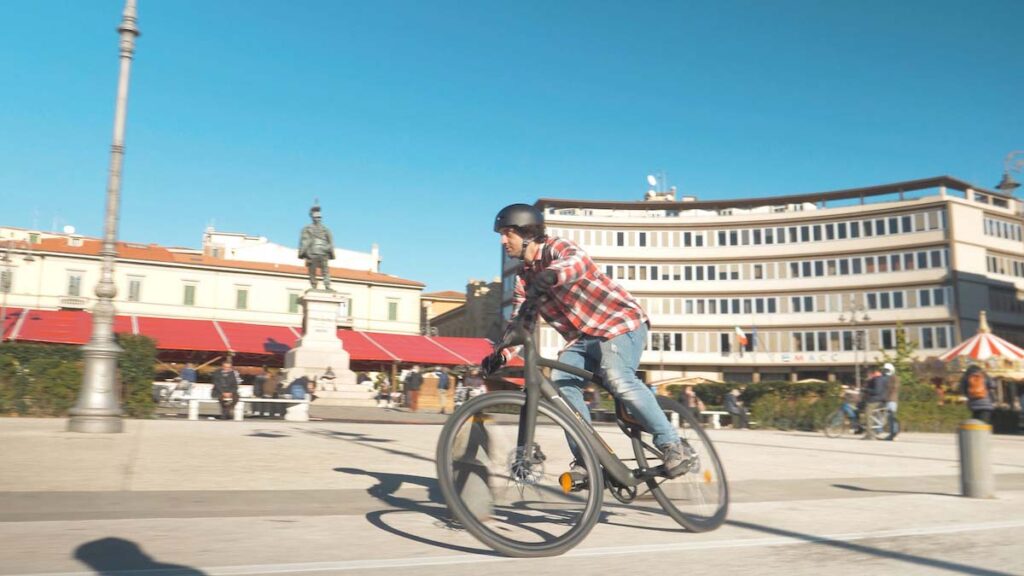 man is riding with an e-bike in the city center
