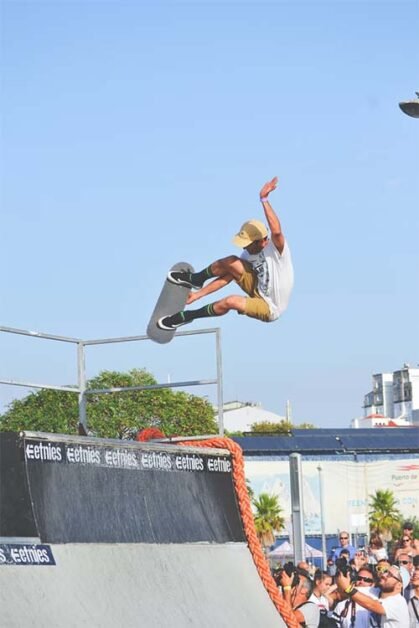 man doing a trick with skateboard in skatepark.