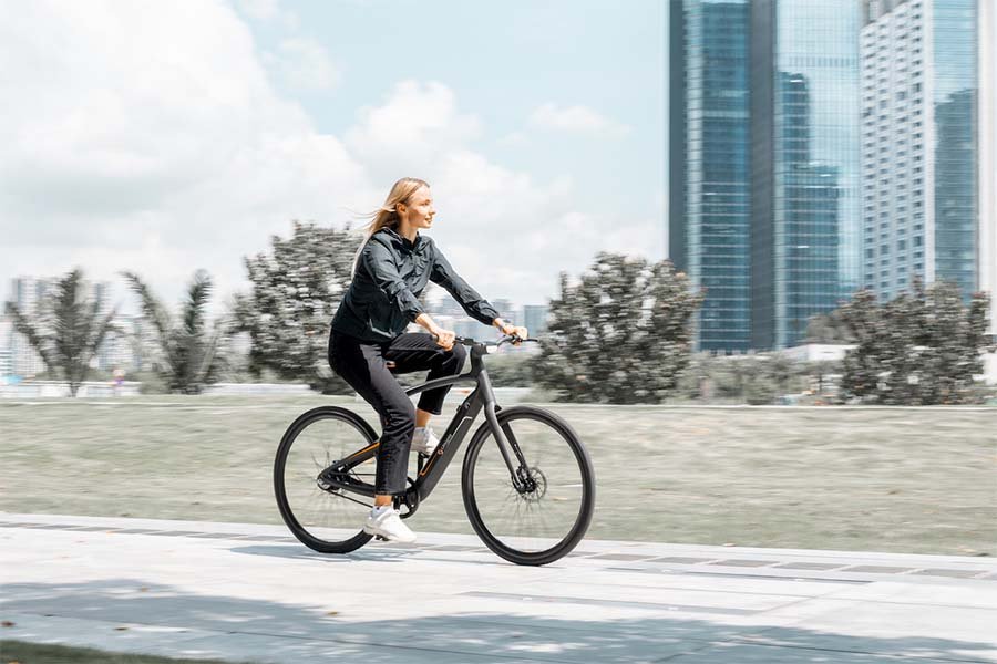 Woman rides Urtopia ebike.