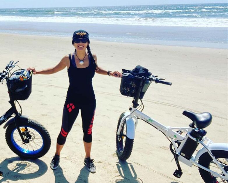 woman with 2 Ecotric fat tire bikes