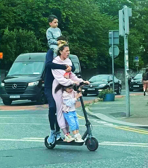 the whole family rides in a one e-scooter