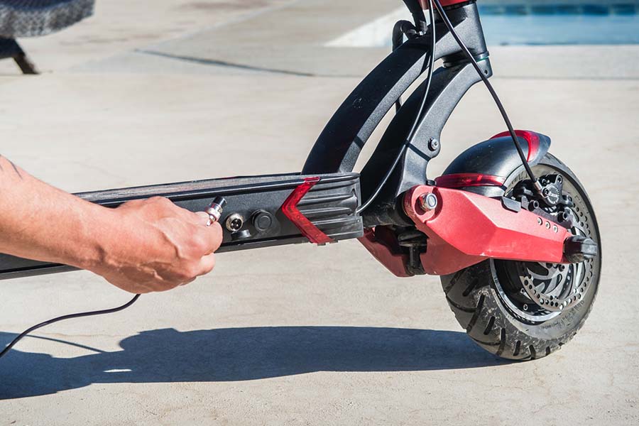 Connecting a charger into the electric scooter