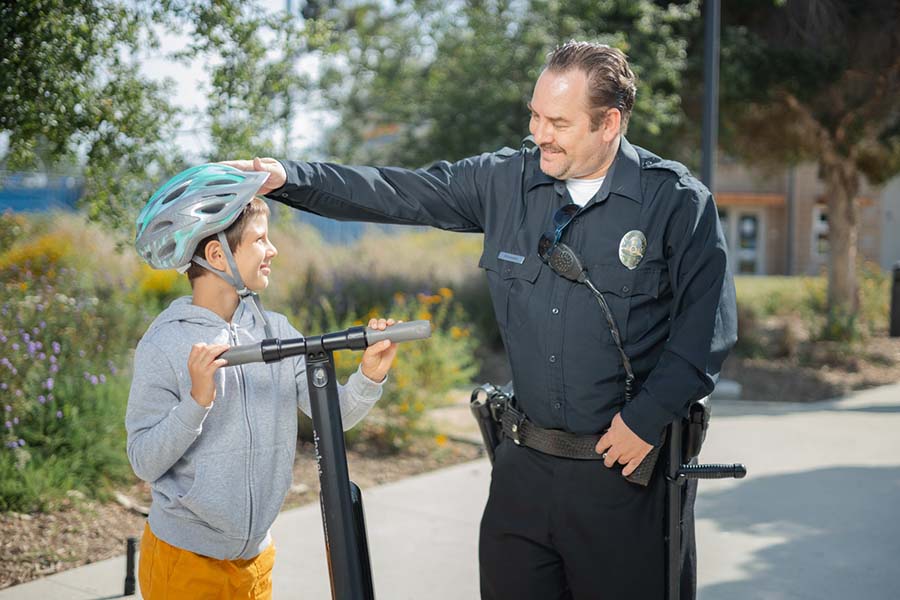 policeman talks with e-scooter rider