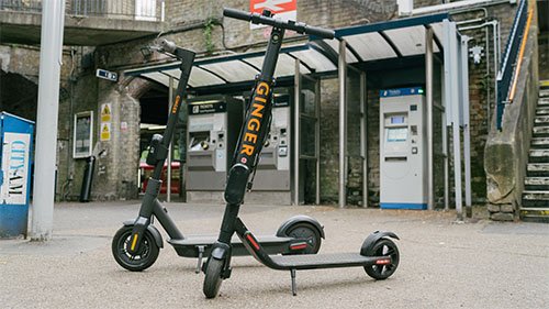 Ginger electric scooters standing on the street