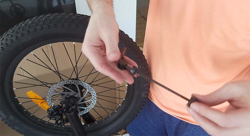 The quick-release skewer of a front wheel.