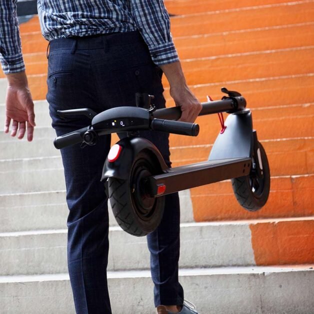 man carrying Turboant electric scooter