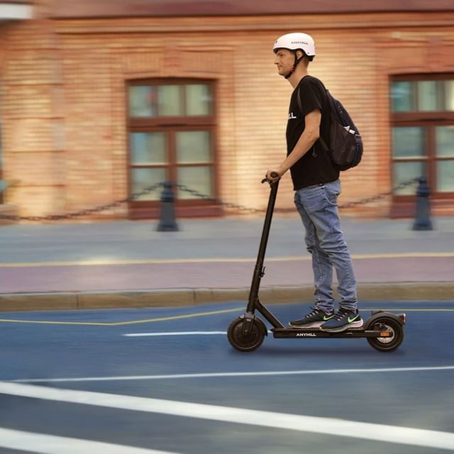 man riding with anyhill um1 scooter