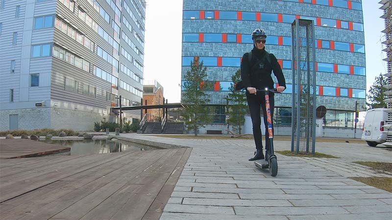 man riding with electric scooter