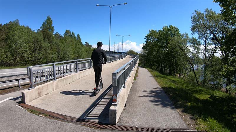 the author of the article riding the scooter up from a bridge ramp