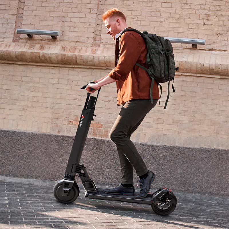 man riding uphill with escooter