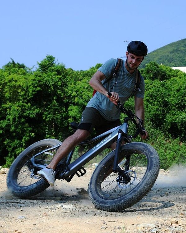 man riding vanpowers bike on the gravel