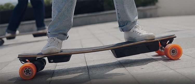 woman standing on a wowgo skateboard