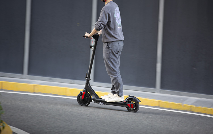 man riding to work with electric scooter