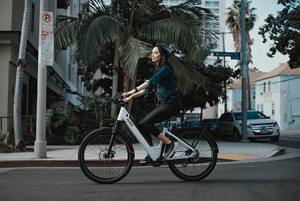 woman feeling relaxed while riding an ebike without pedaling