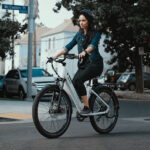 woman practicing how to ride an electric bike