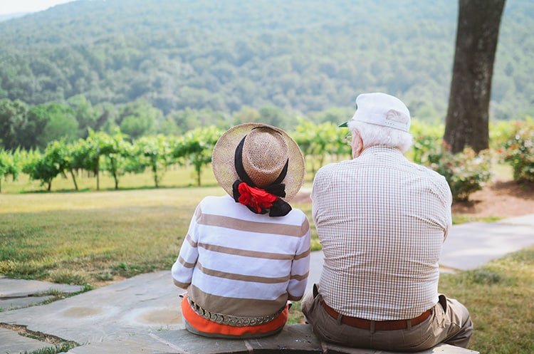 a lovely elderly couple sitting in the park