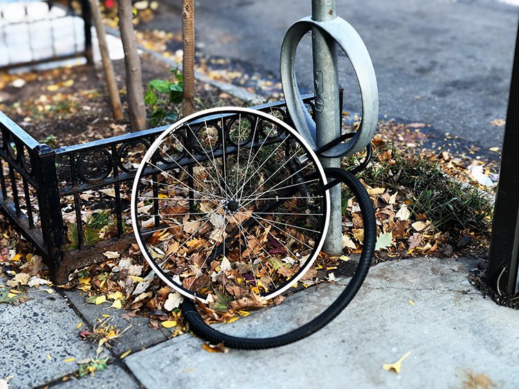 e-bike's front wheel locked to the post, while the bike itself is stolen