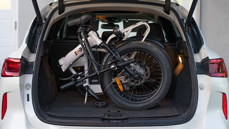 folded kbo electric bike in the trunk of the car