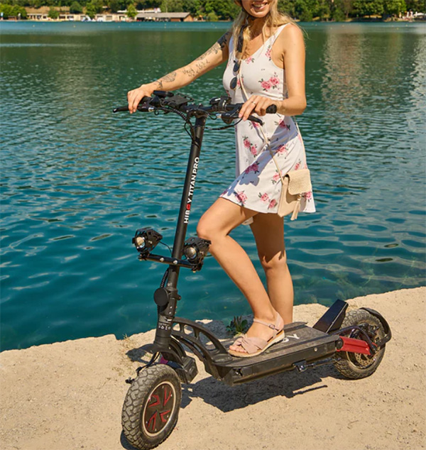 woman posing with hiboy titan pro dual-motor electric scooter