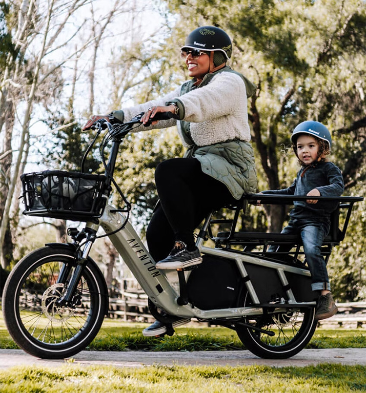 woman carries a kid with her cargo electric bike