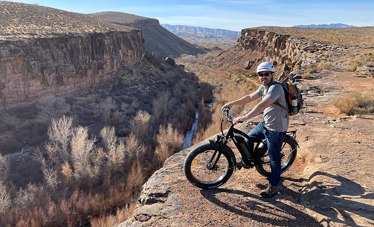 man riding an electric bike on a rocky terrain