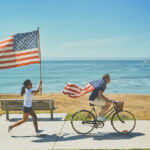 man riding an electric bike with usa flag on the shoulders
