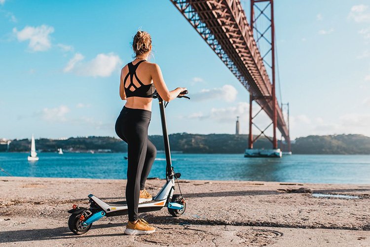 woman riding with Varla Pegasus electric scooter