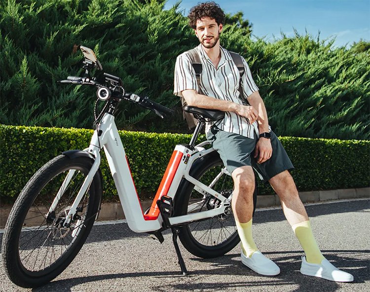 man sitting on a rear rack of niu electric bike