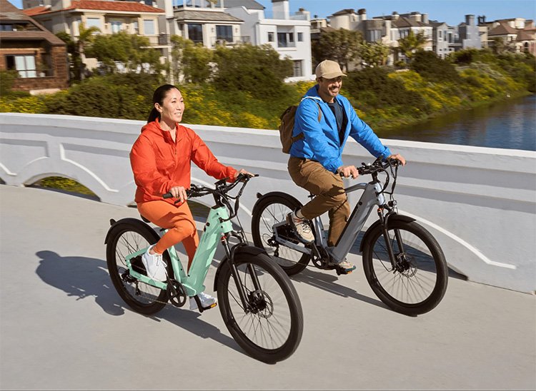 man and woman riding with velotric discover electric bikes