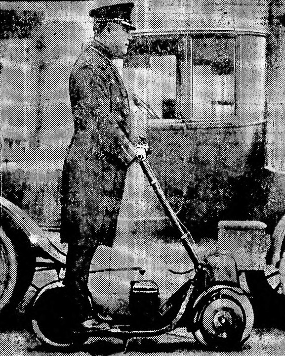 Historical photo of a man riding an autoped.